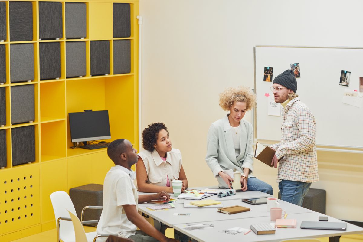 Team working together around laptops in a modern office