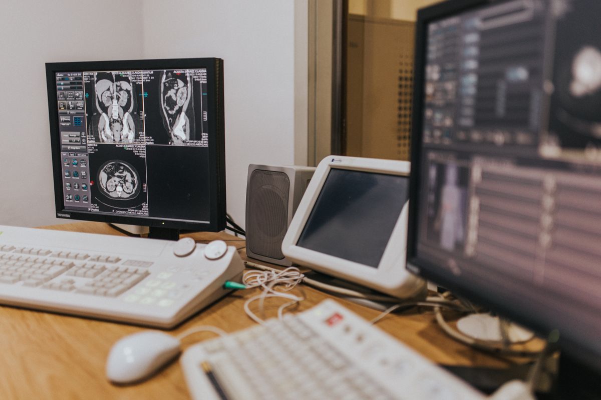 Diagnostic scans displayed across clinical monitors