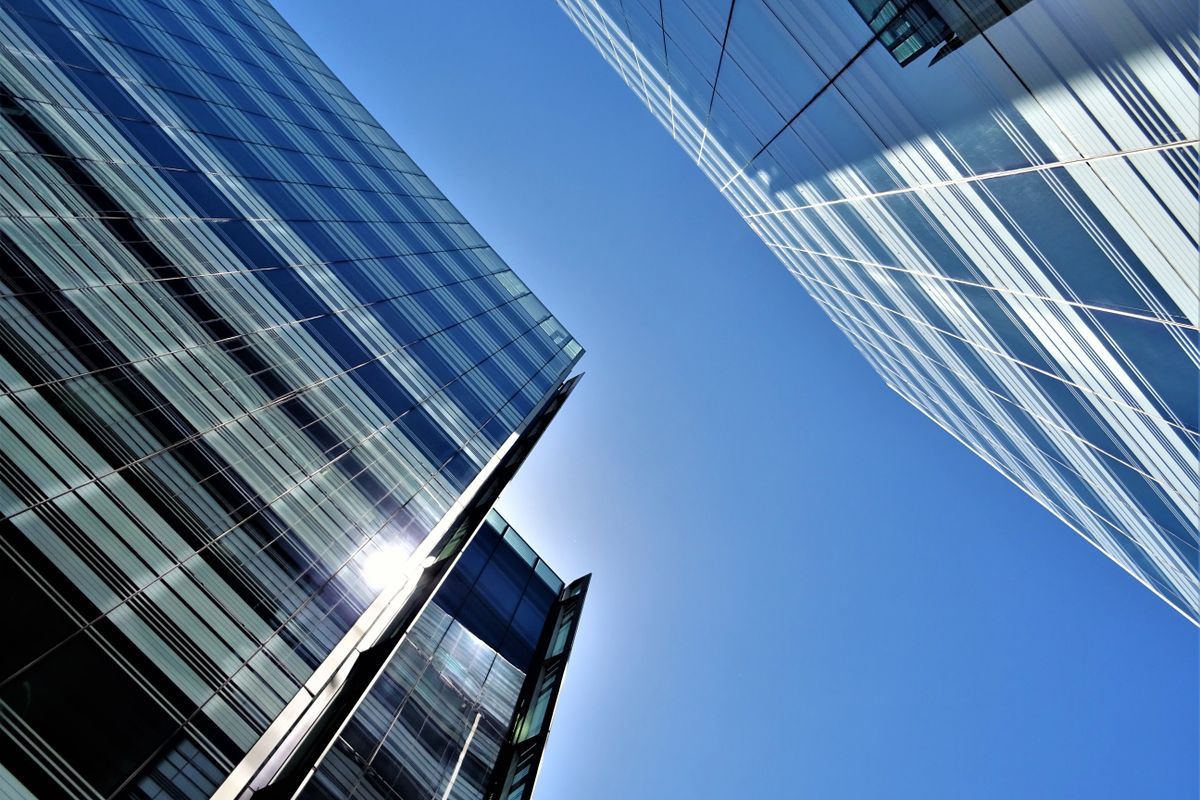 Glass towers reflecting daylight in a city skyline